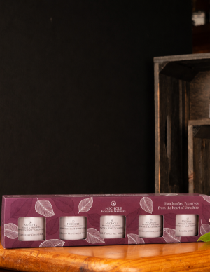 A decorative miniature gift box from Nichols Pickles & Preserves, contains 5 mini jars of chutneys, preserves and conserves.